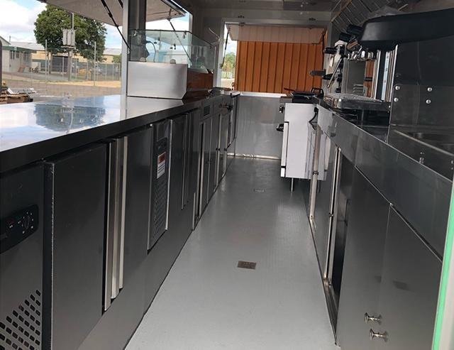 Beverage trailer interior with stainless counters and refrigeration