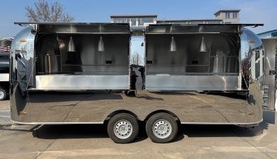 Stainless kitchen trailer with two service windows open