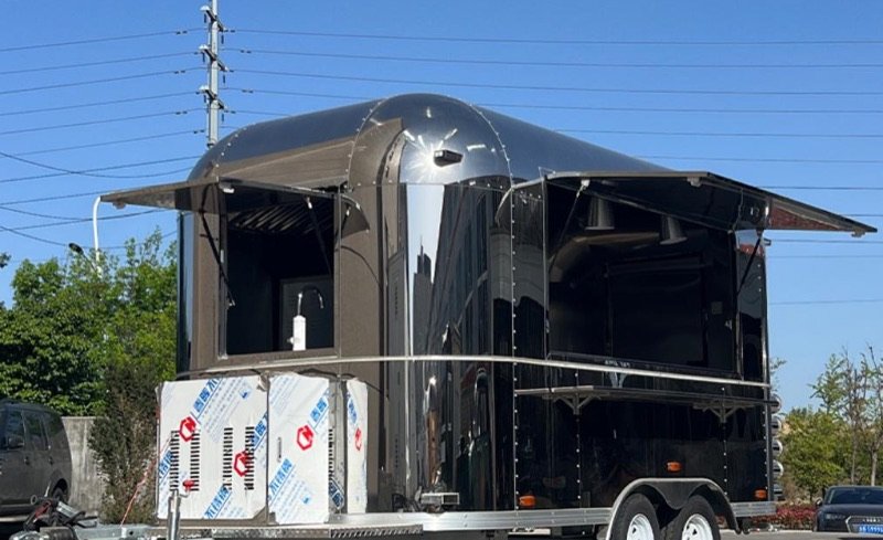 Kitchen trailer with two service windows and awnings open
